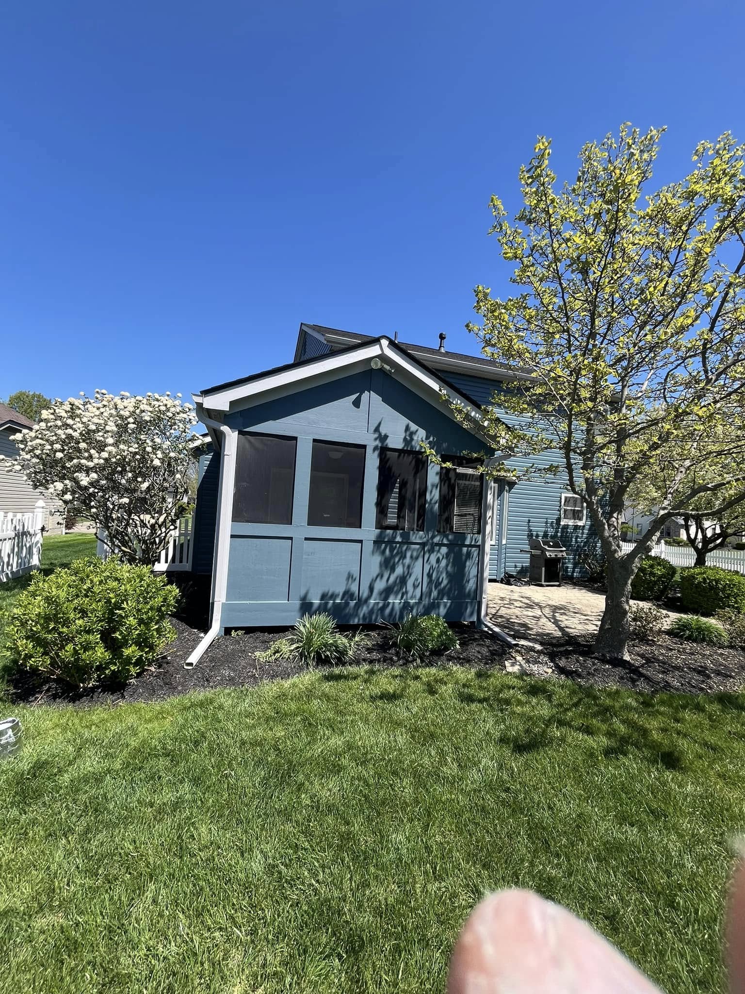 Freshly painted blue screened porch exterior