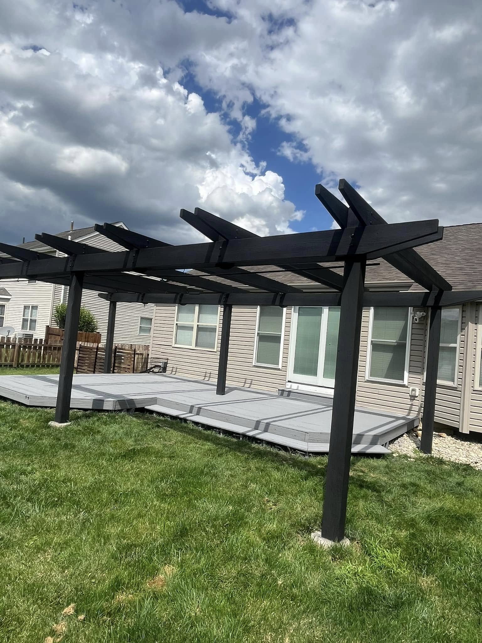 Finished black-stained pergola and deck