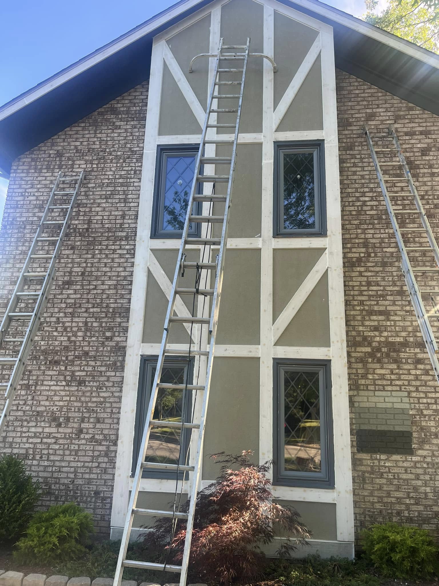 Freshly painted white trim on a two-story Tudor-style gable in Columbus